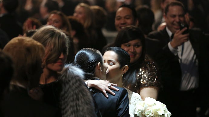 Two women kissing at Macklemore Mass Wedding