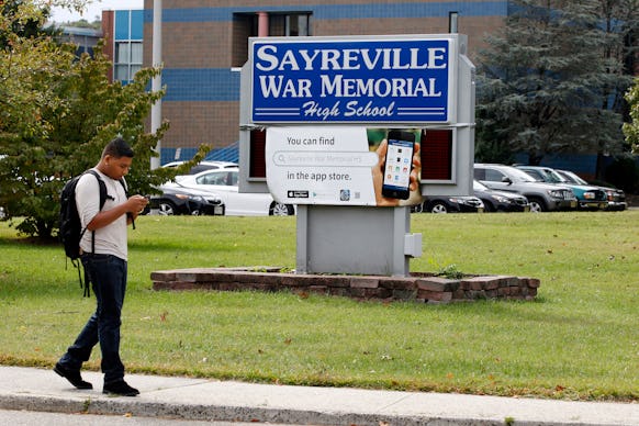 A high-schooler walking in front of the sayreville war memorial