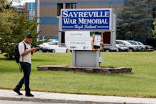 A high-schooler walking in front of the sayreville war memorial