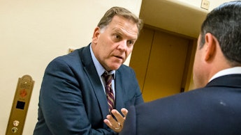 Rep. Mike Rogers speaking to a man next to an elevator