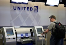 A man checking in for the flight with United Airlines