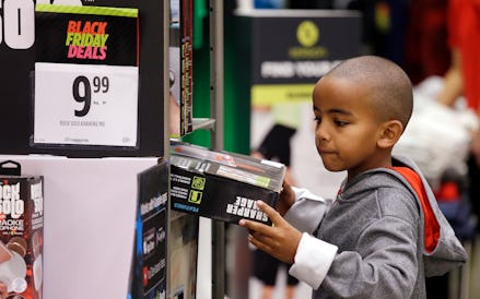 A young boy shopping for Black Friday