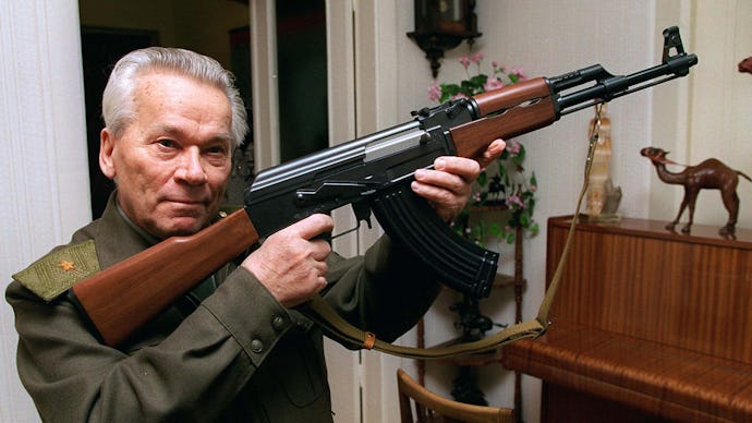 A man in a military uniform holding an ak-47