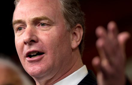 A close-up portrait of Chris Van Hollen speaking with a raised arm