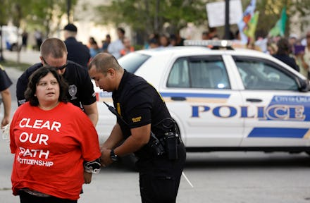 A police officer putting handcuffs on a protester during the Immigration Reform 2013 protest