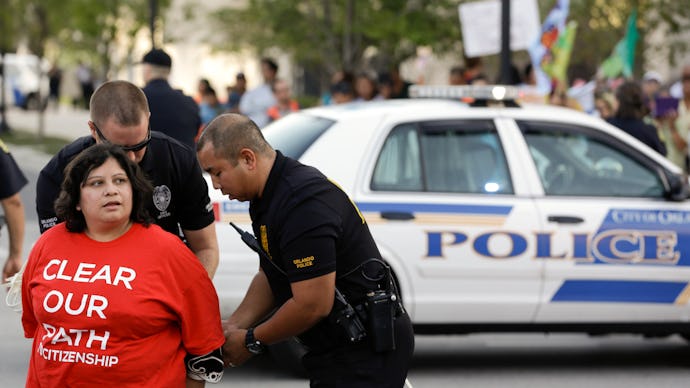 A police officer putting handcuffs on a protester during the Immigration Reform 2013 protest