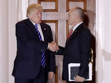 Donald Trump shaking hands with Andrew Puzder