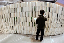 A person browsing a large collection of books.
