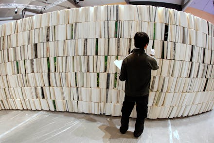 A person browsing a large collection of books.