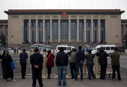 A group of people standing in front of a building during a meeting of China's Third Plenum