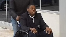 African American high school student Darrin Manning being driven in his wheelchair