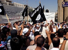 A group of people holding up jihadist flags and signs