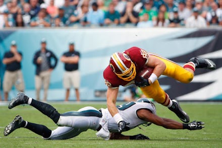 One NFL player tackling another