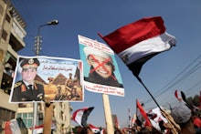 A group of people holding posters with the image of Barack Obama during protests in Egypt