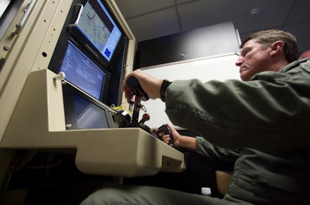 A drone operator at his working station, navigating a drone