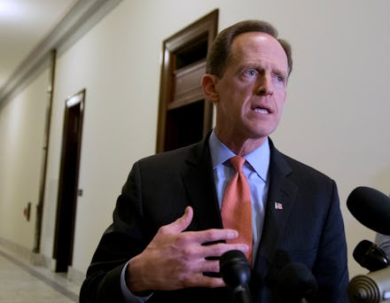 Pat Toomey talking to interviewers who are holding microphones