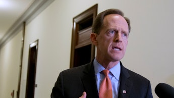 Pat Toomey talking to interviewers who are holding microphones