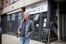 Anthony Bourdain walking on the streets of new york in front of a newly opening restaurant