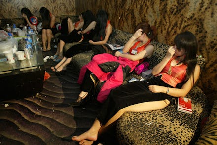 Six prostitutes sitting together at their sex work place
