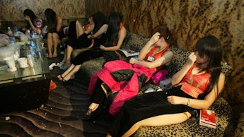 Six prostitutes sitting together at their sex work place