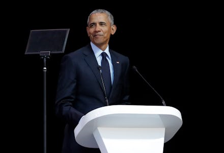 Barack Obama wearing a suit while giving a speech