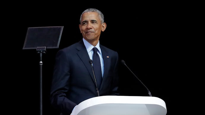 Barack Obama wearing a suit while giving a speech