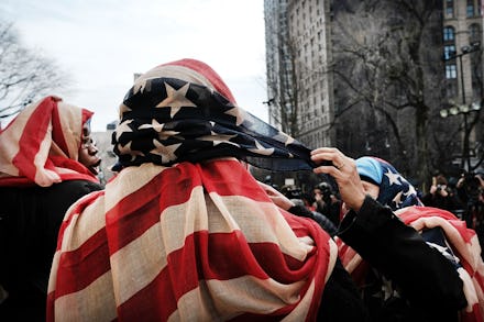 A group of women wearing the American flag as headscarves to cover their hair