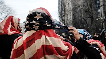 A group of women wearing the American flag as headscarves to cover their hair