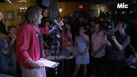 Christine Hallquist giving a speech in a crowded room for the Mic Dispatch episode 14