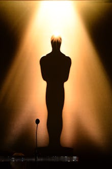 An Oscar award under a spotlight