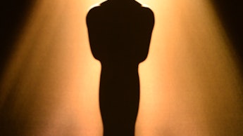An Oscar award under a spotlight