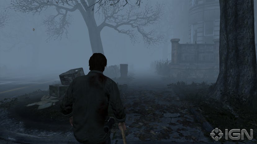 A screenshot from the video game 'Silent Hill' with the character walking through a foggy graveyard