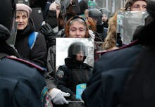 Ukranian protestor holds up a mirror to the police in riot gear