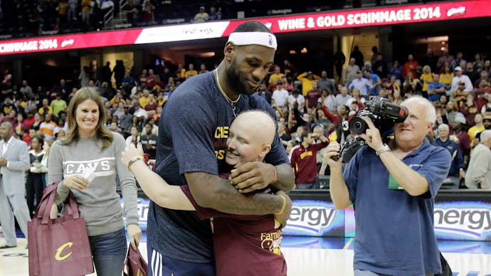 16-year-old fighting leukemia, Jackie Custer, hugging LeBron James during a basketball game