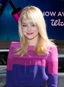 Emma stone in a pink and purple outfit at a red carpet event