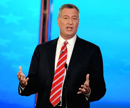 Bill de Blasio in a suit and red striped tie during a debate