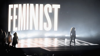 Beyoncé performing at the 2014 VMAs with the word "feminist" lit up behind her