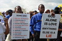 A group of protestors protesting gay rights with signs talking about how gay rights are a sin