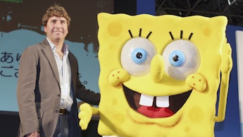 Stephen Hillenburg posing for a photo with a SpongeBob mascot 