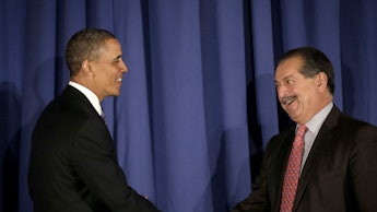Obama shakes hands with Andrew Liveris, CEO of Dow Chemical Company