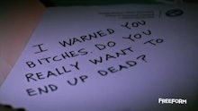 "I warned you bitches, do you really want to end up dead?" written text on a paper