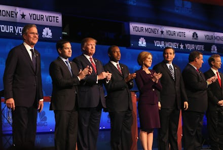 Donald Trump and a group of people standing on a stage and applauding