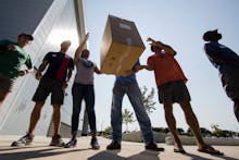 People carrying help packages for Hurricane Maria victims in Puerto Rico