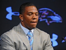 Ray Rice in a grey blazer, white shirt, and a blue-beige tie