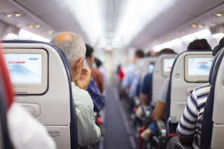 A view of the seats and the aisle in an overbooked flight