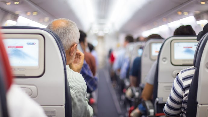 A view of the seats and the aisle in an overbooked flight