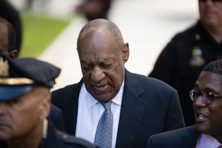 Bill Cosby escorted by a group of men during day 4 of the Bill Cosby sexual assault trial