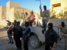 A group of terrorists posing with riffles and face masks 