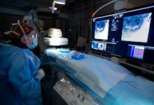 A doctor in a prepared hospital room for a surgery