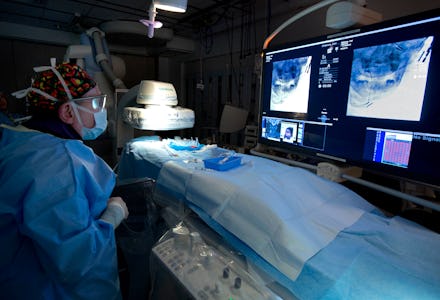 A doctor in a prepared hospital room for a surgery